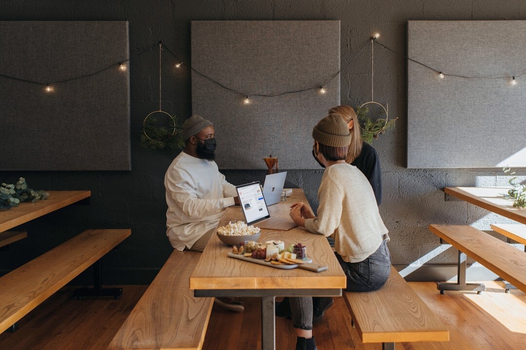 Colleagues collaborating around a table with a tablet